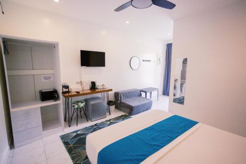 a bedroom with a bed and a chair and a desk at Selectum Mangrove Resort in Panglao