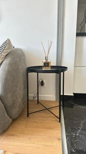 a black table sitting next to a couch at Suite luxueuse Avenue des Champs-Élysées in Paris