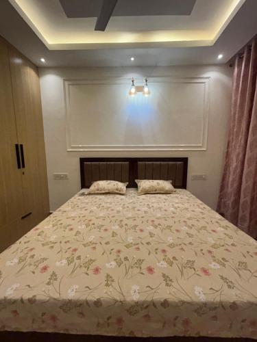 a bedroom with a large bed with flowers on it at Nivaasa Luxe in Kharar