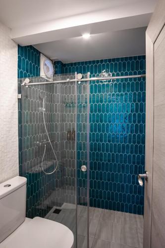 a bathroom with a glass shower with a toilet at Le Wiang in Chiang Mai