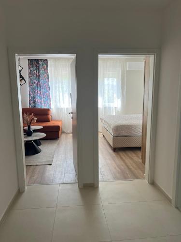 a view of a room with a bed and a living room at Mali Raj in Ljubuški