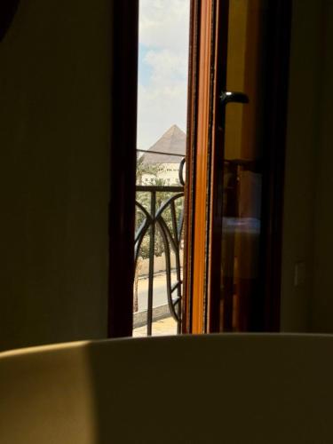 a view of the eiffel tower through a window at Almas Pyramids Hotel in Cairo