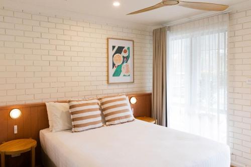 a bedroom with a white bed and a window at The Lodge At The Denmark Hotel in Denmark