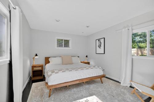 a white bedroom with a bed and a window at The Palms Mirage House home in Millman