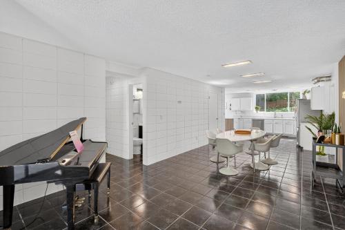 a living room with a piano and a table at The Palms Mirage House home in Millman