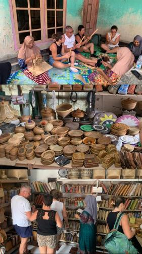a group of people in a room with baskets at Farmer homestay in Tetebatu