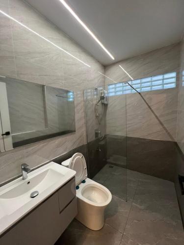a bathroom with a shower and a toilet and a sink at Cheeva Home #1 in Ban Pa Tung (7)
