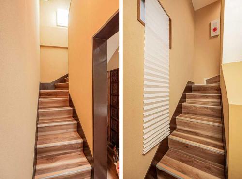 a staircase in a house with wood floors and a window at Hotel Ginnan in Tokyo