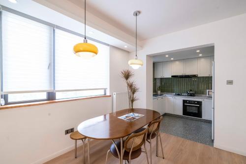 a kitchen and dining room with a wooden table and chairs at Book and Bed-People's Square in Shanghai