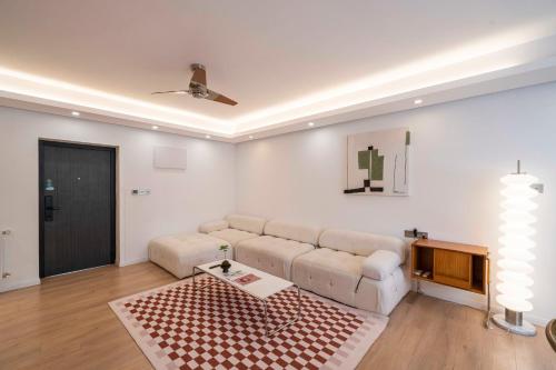 a living room with a couch and a table at Book and Bed-People's Square in Shanghai