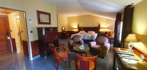a living room with chairs and a table and a dining room at Demeures & Châteaux - Hôtel Greuze & Spa Tournus in Tournus