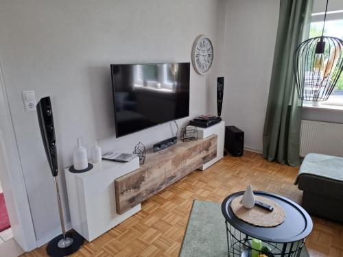a living room with a large flat screen tv on a wall at FeWo Fortysix in Mendig