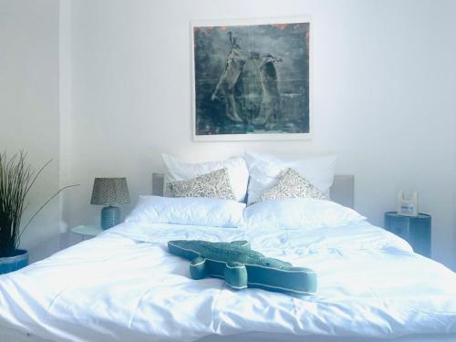 a white bed with a pair of shoes on it at Naturerlebnis direkt am Traumpfad in Andernach