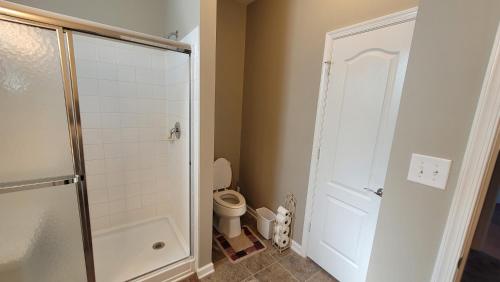 a small bathroom with a toilet and a shower at Cozy SFH for Active Adults in Middletown