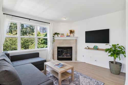 a living room with a couch and a fireplace at Walkable Seattle Gem Close To Everything condo in Seattle