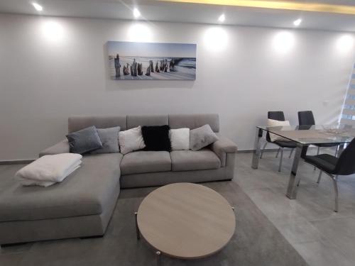 a living room with a couch and a table at San Pawl Lodge Hostel in St Paul's Bay