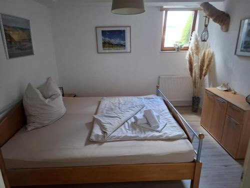 a bedroom with a bed with a napkin on it at FeWo Fortysix in Mendig