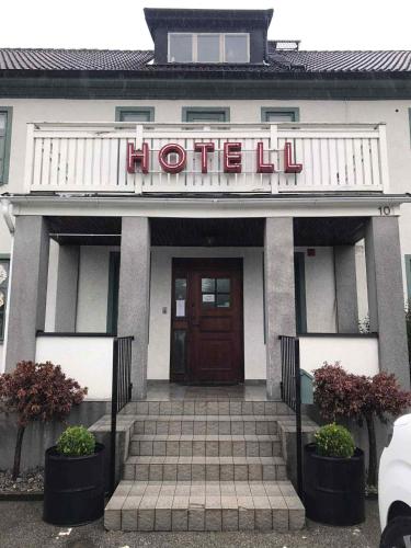 a hotel building with a sign that reads hotel at Solsta Towers in Asarum
