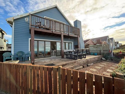 a house with a deck with a wooden fence at CASA MIA in Witsand