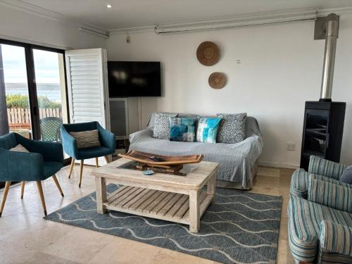 a living room with a couch and a coffee table at CASA MIA in Witsand