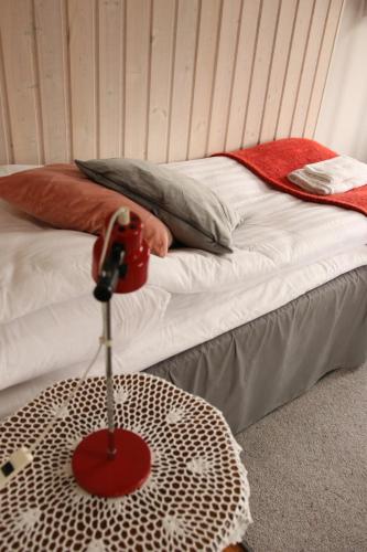 a room with a bed with a table on it at Solsta Towers in Asarum