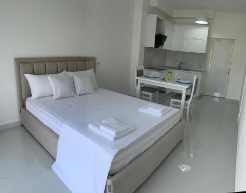 a small bedroom with a bed and a small kitchen at Relax Villa in Vlorë
