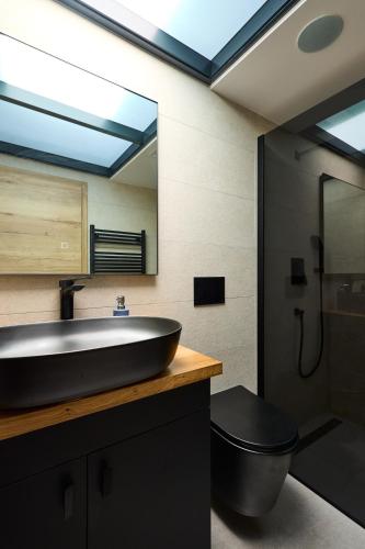 a bathroom with a sink and a toilet and a mirror at Galboka Nine in Nerezine