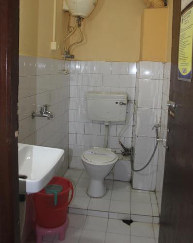 a small bathroom with a toilet and a sink at Hotel Utpala in Gangtok
