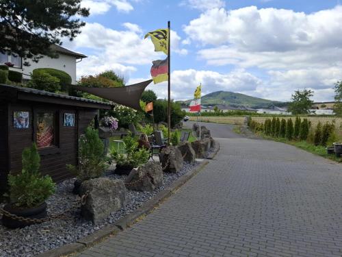 a road with flags and a building with rocks at FeWo Fortysix in Mendig