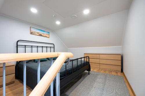 a bedroom with a bunk bed and a staircase at Brand new Kalma Apartments in Tallinn