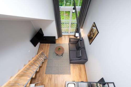 an overhead view of a living room with a staircase at Brand new Kalma Apartments in Tallinn