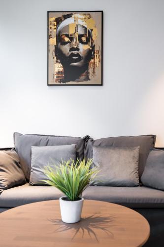 a living room with a couch and a table at Brand new Kalma Apartments in Tallinn
