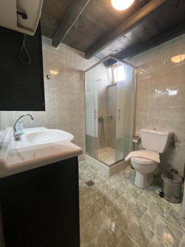 a bathroom with a toilet and a sink and a shower at Casa Paros in Parikia