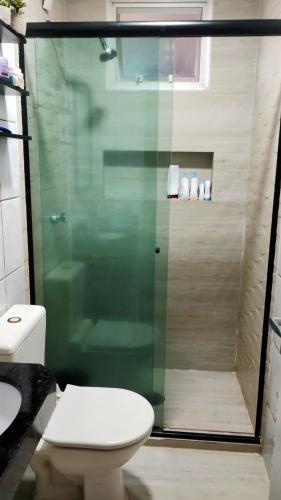 a bathroom with a toilet and a glass shower at Belém Cop 30 in Belém