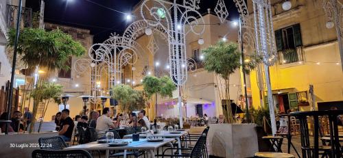 a group of people sitting at tables in a restaurant at "Casa Simone" in Leverano