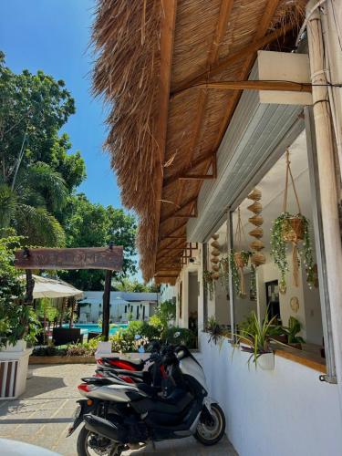 a scooter parked outside of a building with a building at Alona Garden Suites in Panglao