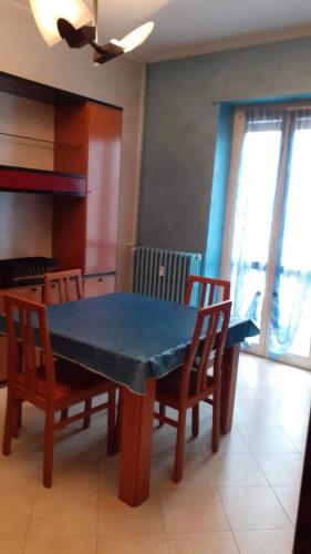 a dining room table with chairs and a blue table at B&B Apartment in Settimo Torinese