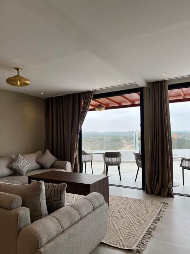 a living room with a couch and a table and chairs at Cruiser Mogador Essaouira in Essaouira