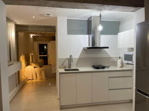 a kitchen with white cabinets and a sink at Ian's House in La Garita