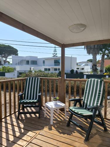 two chairs and a coffee table on a deck at Maria Meco in Sesimbra