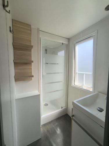 a bathroom with a white refrigerator and a sink at Maria Meco in Sesimbra