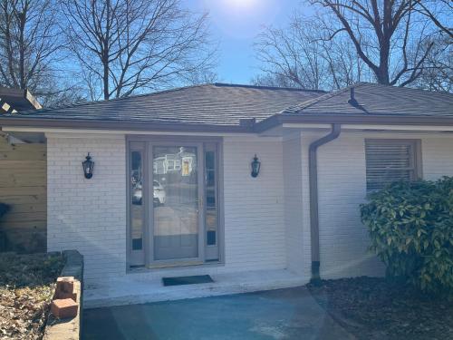 a small white house with a front door at La Casa de Tutti in Decatur