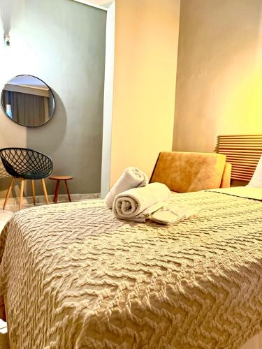 a hotel room with a bed with a towel on it at ESPERIA Drama HOTEL in Drama