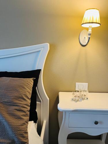 a bedside table with a lamp next to a bed at Agriturismo Tenuta il Molino in Gabbro