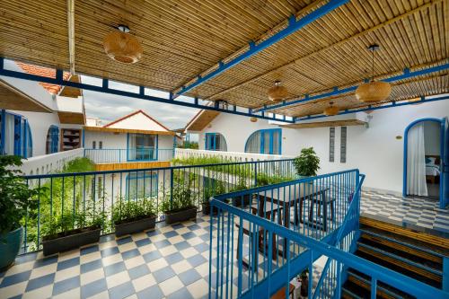 a balcony of a building with a blue railing at The Linh Coastline Villa in Hoi An
