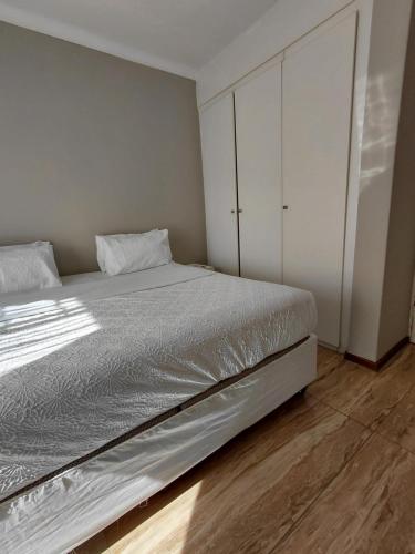 a bedroom with a large bed and white cabinets at Mont Pelaan 88 in Newcastle