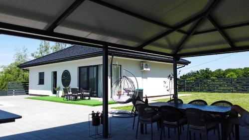 a patio with a table and chairs under a tent at La Casa di Anna in Slatina Varoš