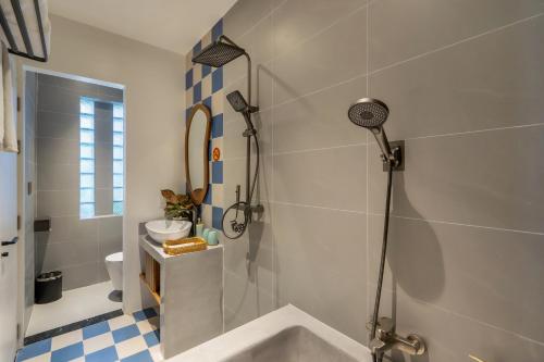 a bathroom with a shower and a sink at The Linh Coastline Villa in Hoi An