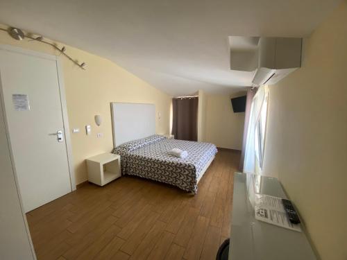 a small room with a bed in a room at Via Mameli 5 in Sanremo