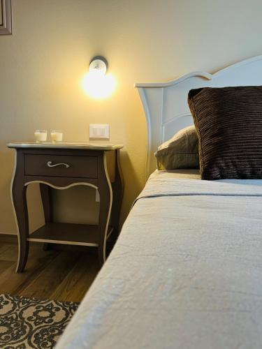 a bedroom with a bed with a nightstand next to a bed with a bed at Agriturismo Tenuta il Molino in Gabbro